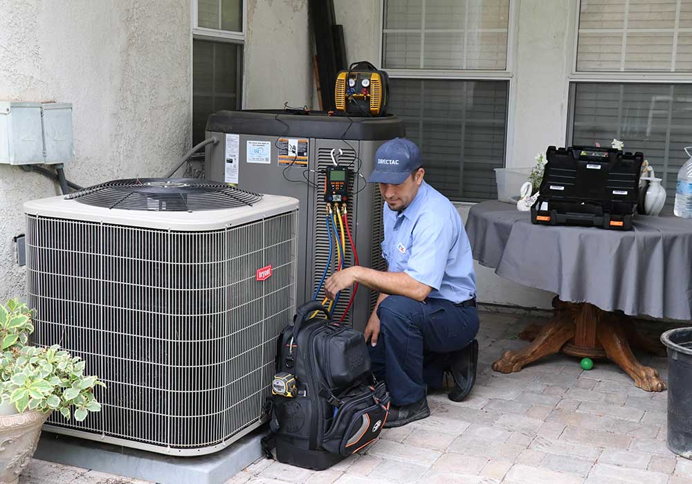 directac HVAC expert repairing residential AC unit in Riverside home