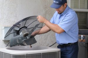 technician inspecting air conditioner during repair in Riverside
